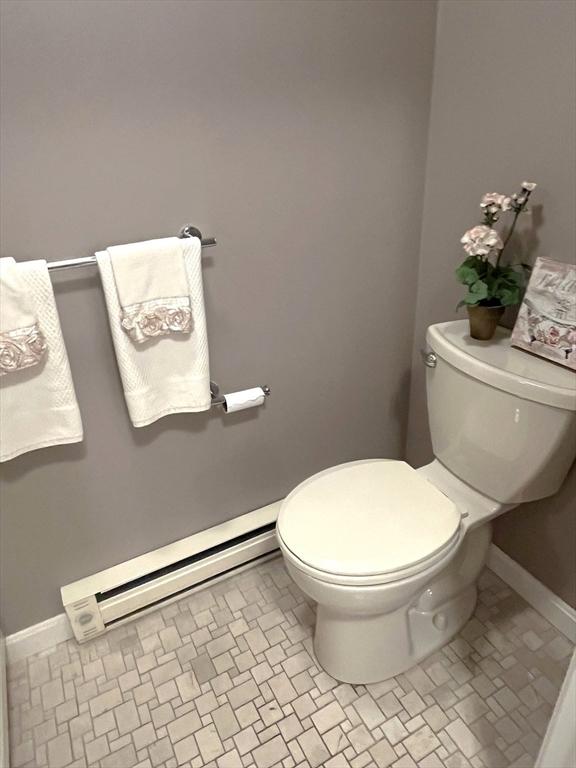 38 Hammond Pl Unit 38, Woburn, MA 01801 - half bathroom featuring a baseboard heating unit and toilet