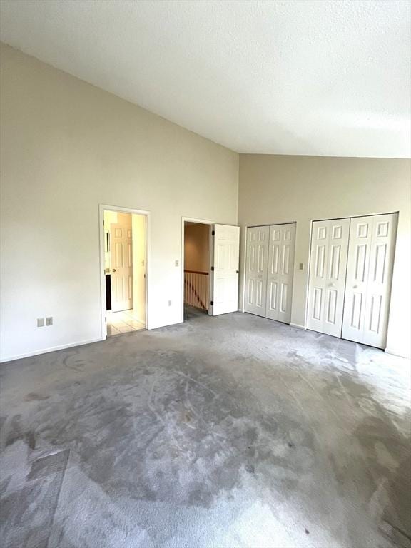38 Hammond Pl Unit 38, Woburn, MA 01801 - unfurnished bedroom with high vaulted ceiling, two closets, and carpet