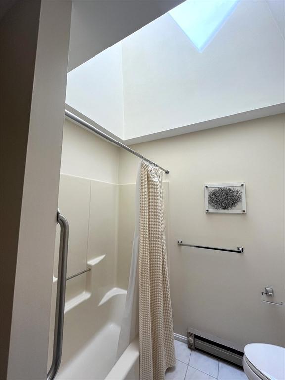 38 Hammond Pl Unit 38, Woburn, MA 01801 - bathroom with a baseboard heating unit, tile patterned floors, and shower / tub combo with curtain