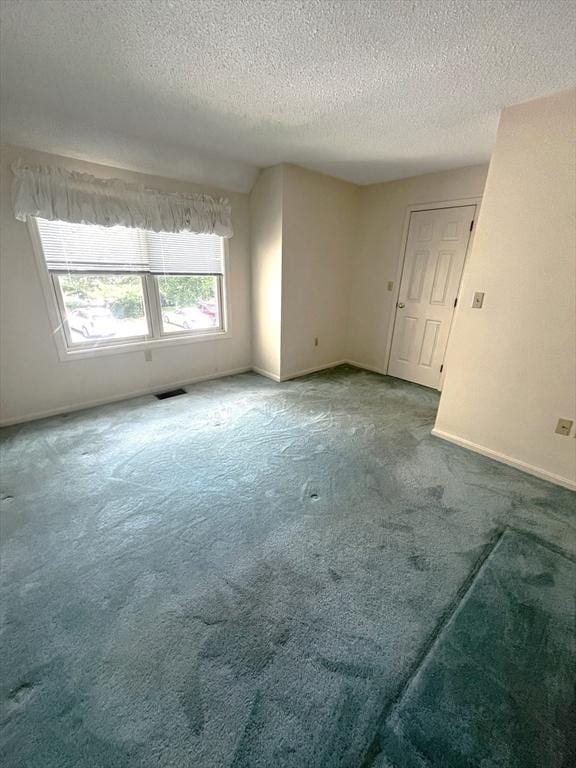 38 Hammond Pl Unit 38, Woburn, MA 01801 - carpeted spare room featuring a textured ceiling and baseboards