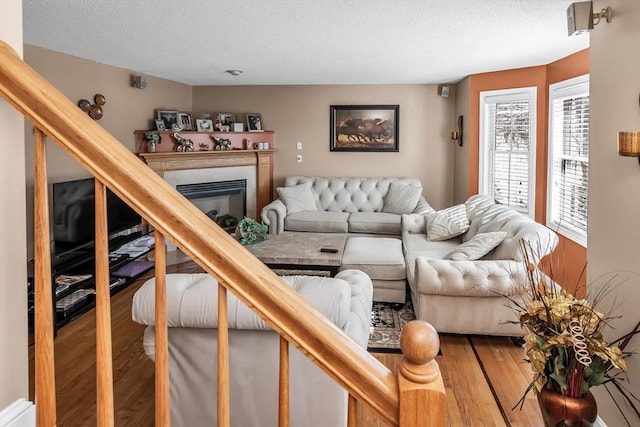 living room featuring hardwood / wood-style floors and a textured ceiling