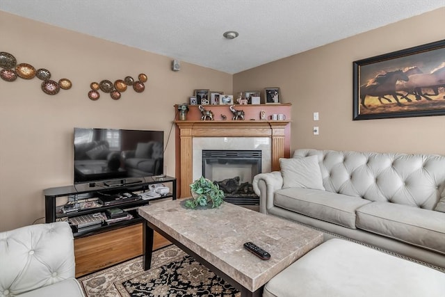 living room featuring lofted ceiling, a fireplace, and hardwood / wood-style floors