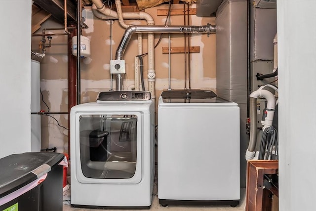 clothes washing area featuring independent washer and dryer