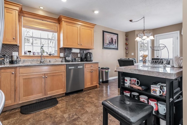 kitchen featuring sink, dishwasher, backsplash, hanging light fixtures, and light stone counters