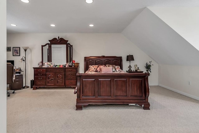 bedroom with vaulted ceiling and light colored carpet