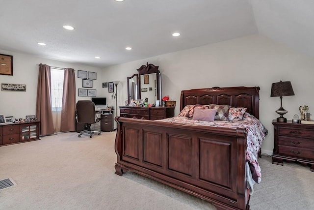 bedroom with light carpet and lofted ceiling