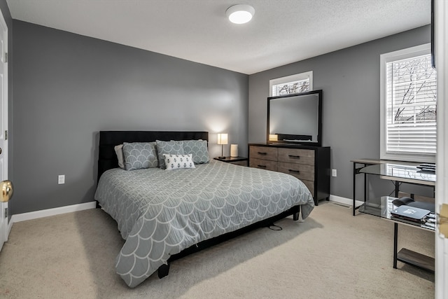 bedroom with carpet and a textured ceiling