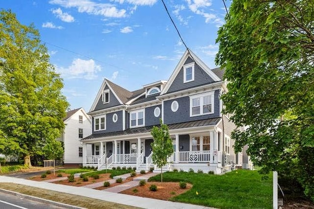162 Swanton St Unit 162, Winchester, MA 01890 - view of front of house featuring a porch, a standing seam roof, metal roof, and a front yard
