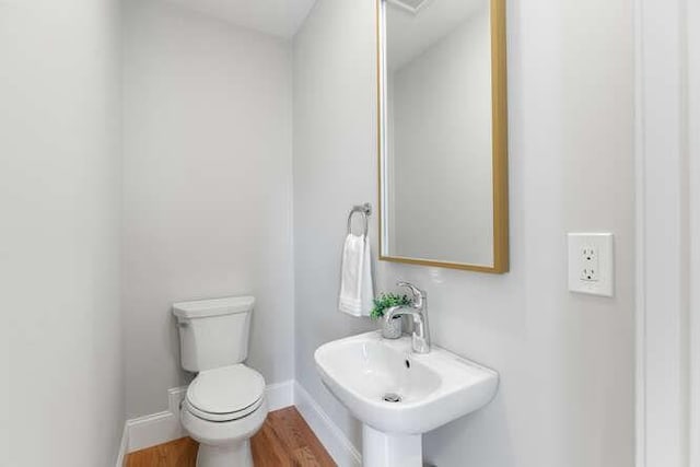 162 Swanton St Unit 162, Winchester, MA 01890 - bathroom featuring wood finished floors, toilet, baseboards, and a sink