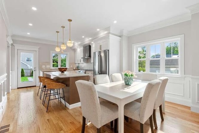 162 Swanton St Unit 162, Winchester, MA 01890 - dining space featuring crown molding, a decorative wall, light wood-style floors, a wainscoted wall, and recessed lighting