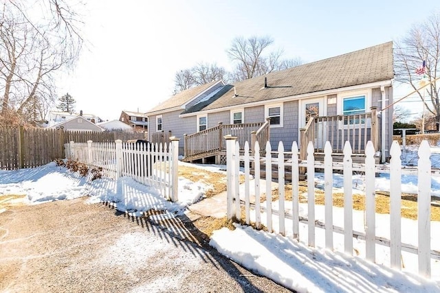 snow covered property featuring a wooden deck