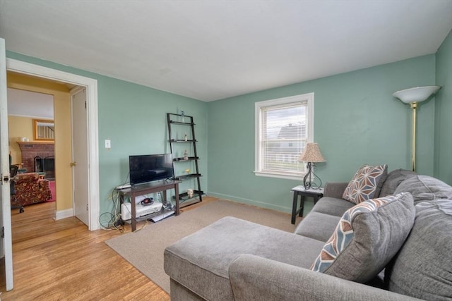 208 Green St, Weymouth, MA 02191 - living area with baseboards, light wood-style floors, and a fireplace