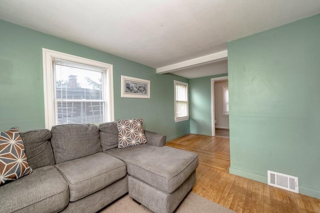 208 Green St, Weymouth, MA 02191 - living area with light wood-type flooring, baseboards, and beam ceiling