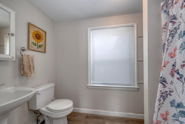 208 Green St, Weymouth, MA 02191 - bathroom featuring wood finished floors, toilet, baseboards, a shower with curtain, and a sink