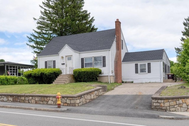 208 Green St, Weymouth, MA 02191 - cape cod house featuring asphalt driveway, a chimney, a front lawn, and a shingled roof