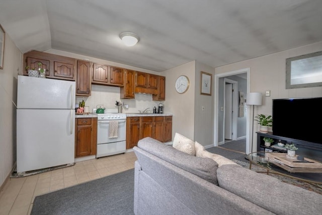 208 Green St, Weymouth, MA 02191 - kitchen featuring white appliances, light countertops, brown cabinets, and light tile patterned floors