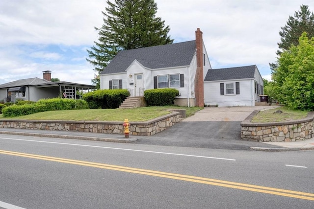 208 Green St, Weymouth, MA 02191 - new england style home featuring asphalt driveway, a front yard, and a chimney