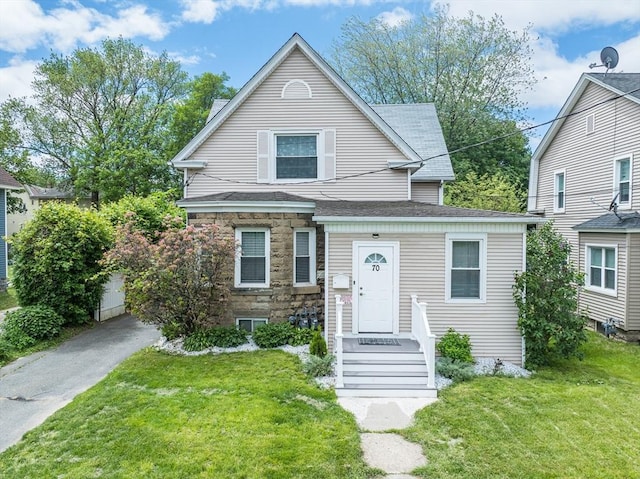 70 Riverdale St, West Springfield, MA 01089 - view of front facade featuring stone siding, a front lawn, and a shingled roof