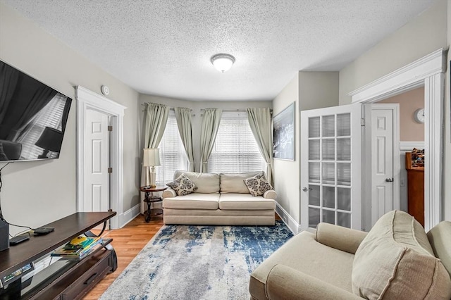 70 Riverdale St, West Springfield, MA 01089 - living room featuring light wood-style floors, a textured ceiling, and baseboards