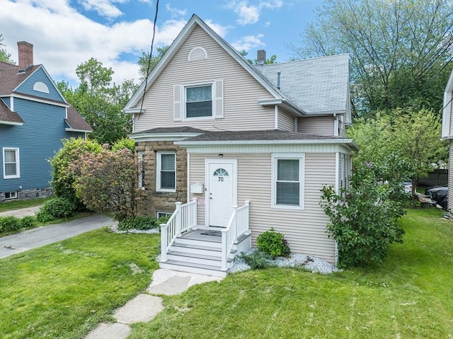 70 Riverdale St, West Springfield, MA 01089 - view of front of home featuring a front lawn, a shingled roof, and stone siding