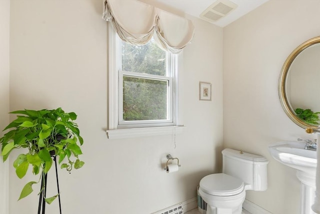 half bathroom featuring toilet and visible vents