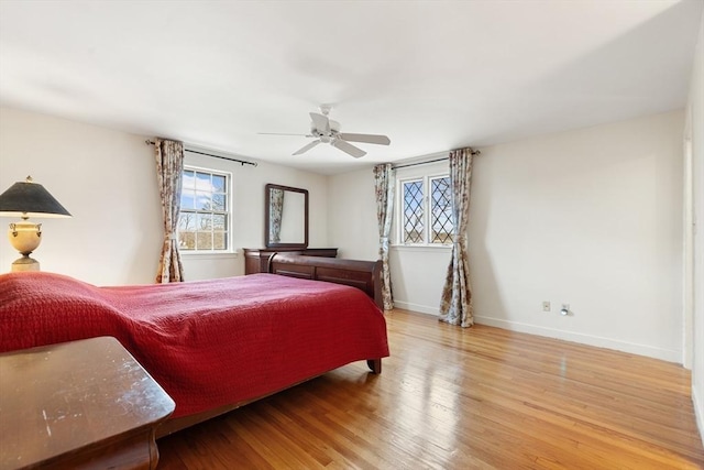 bedroom featuring ceiling fan, wood finished floors, and baseboards