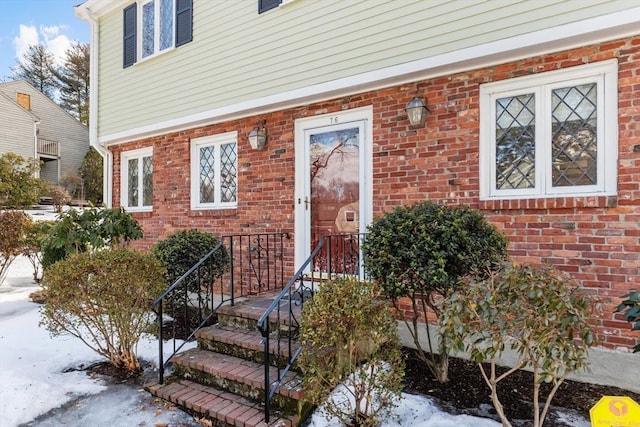 view of exterior entry with brick siding