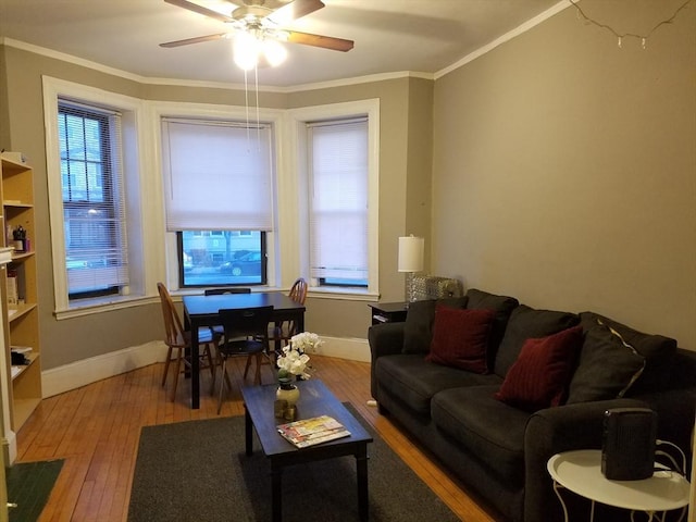 living room featuring hardwood / wood-style flooring, crown molding, a wealth of natural light, and ceiling fan