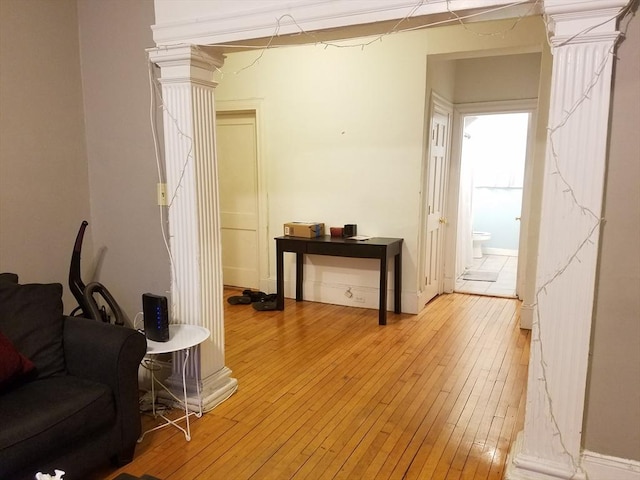 interior space with hardwood / wood-style flooring and ornate columns