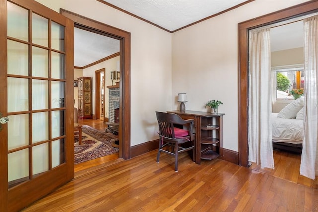 office with ornamental molding, wood finished floors, and baseboards