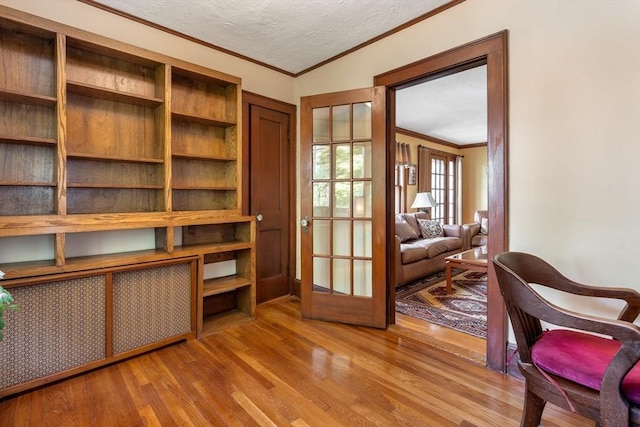 office featuring crown molding, wood finished floors, and a textured ceiling