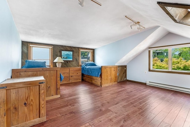bedroom featuring a baseboard radiator, wood-type flooring, rail lighting, lofted ceiling, and wood walls