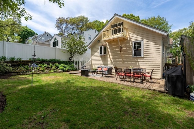 rear view of house featuring a balcony, a patio, and an outdoor living space