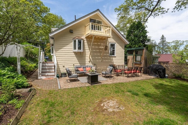 back of property featuring outdoor lounge area, a balcony, and a patio