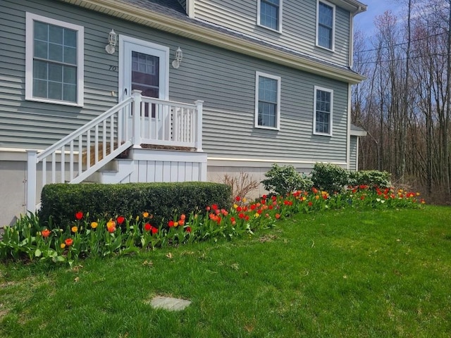 doorway to property featuring a lawn