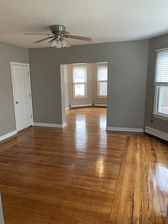 58 Ames Ave, Chicopee, MA 01013 - empty room featuring healthy amount of natural light, a baseboard heating unit, and wood finished floors