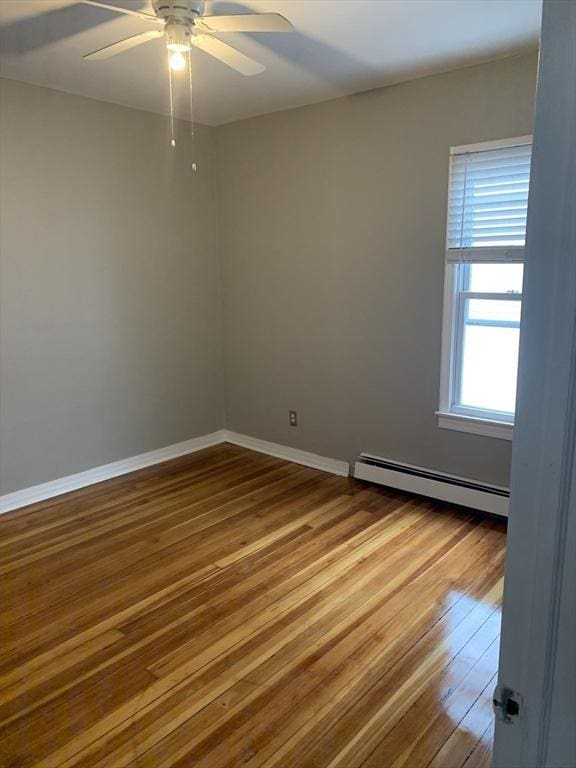 58 Ames Ave, Chicopee, MA 01013 - empty room with baseboard heating, hardwood / wood-style floors, ceiling fan, and baseboards
