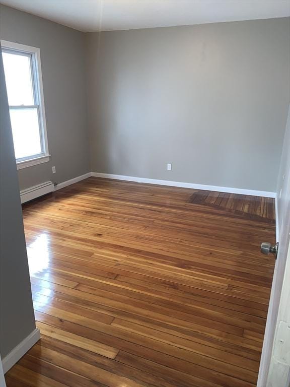 58 Ames Ave, Chicopee, MA 01013 - empty room featuring a baseboard heating unit, hardwood / wood-style floors, and baseboards
