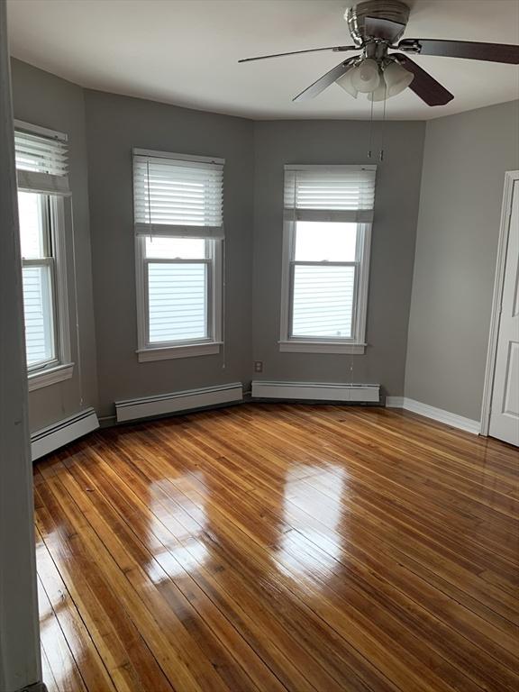 58 Ames Ave, Chicopee, MA 01013 - spare room featuring baseboard heating, hardwood / wood-style floors, and ceiling fan