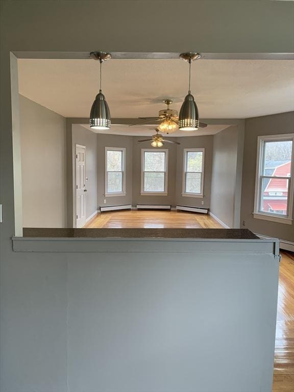 58 Ames Ave, Chicopee, MA 01013 - kitchen featuring baseboard heating, plenty of natural light, light wood-style flooring, and a ceiling fan