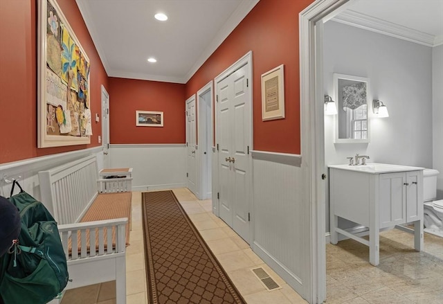 corridor with sink and ornamental molding