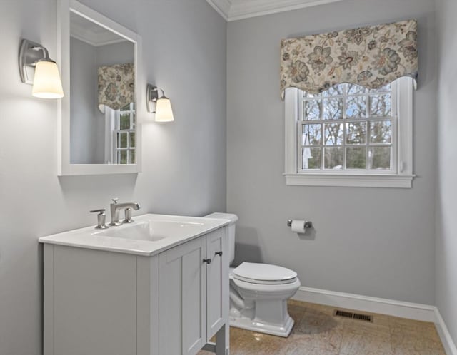 bathroom featuring ornamental molding, vanity, and toilet