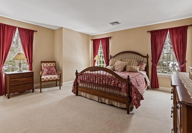 carpeted bedroom featuring multiple windows