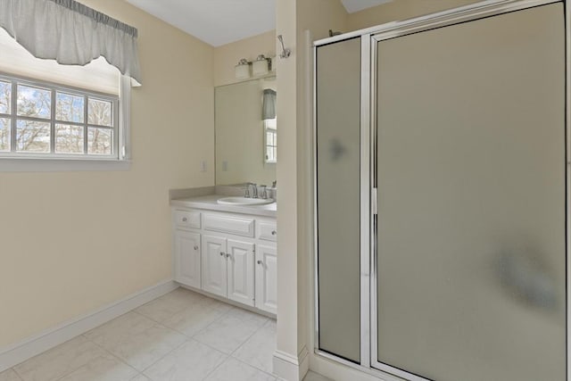 bathroom featuring a shower with door, vanity, and tile patterned floors