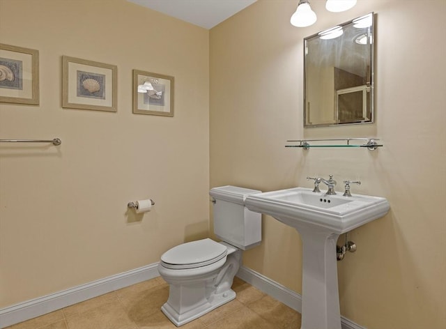 bathroom featuring toilet, tile patterned flooring, and sink