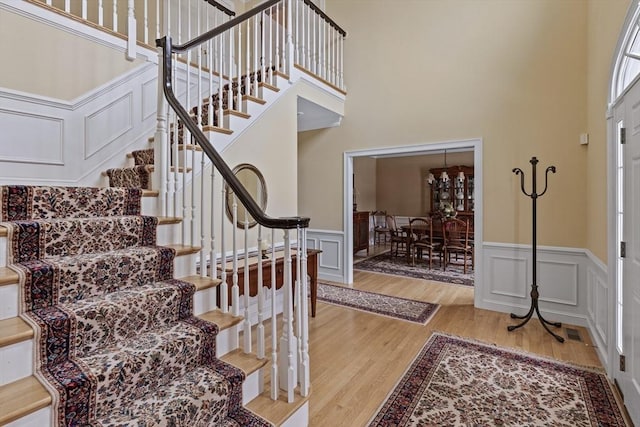 foyer featuring a high ceiling and light hardwood / wood-style flooring