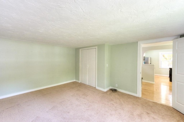 197 Eastern Ave, Worcester, MA 01605 - carpeted empty room with a textured ceiling and baseboards