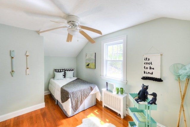197 Eastern Ave, Worcester, MA 01605 - bedroom with radiator, vaulted ceiling, wood finished floors, baseboards, and ceiling fan