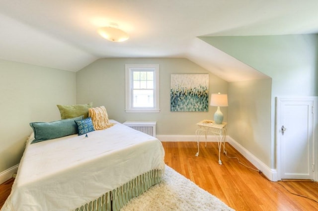 197 Eastern Ave, Worcester, MA 01605 - bedroom featuring lofted ceiling, light wood-type flooring, baseboards, and radiator