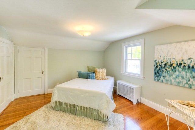 197 Eastern Ave, Worcester, MA 01605 - bedroom with radiator, lofted ceiling, wood finished floors, and baseboards